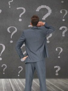 cropped-pensive-man-with-question-marks-background-1.jpg
