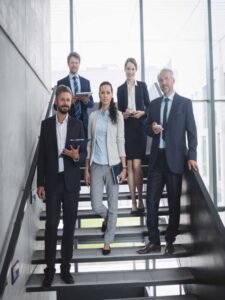 Cinco empresarios na escada.